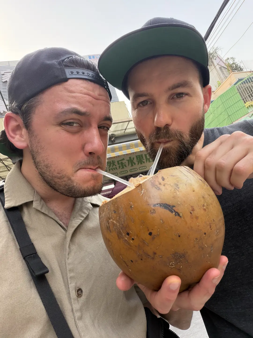 Person drinking from a coconut with eyes closed, golden hour outdoor