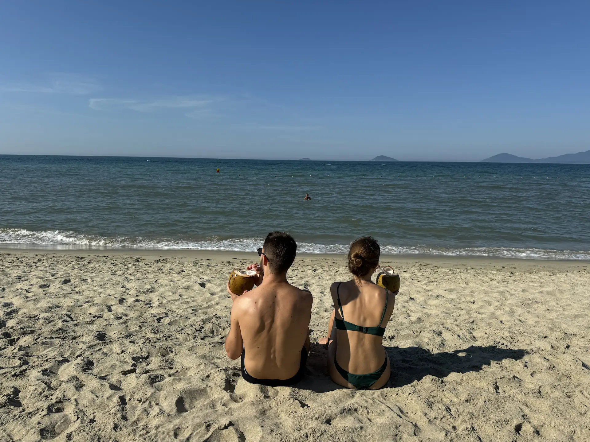 A lone figure on the Hội An shore at the end of the day